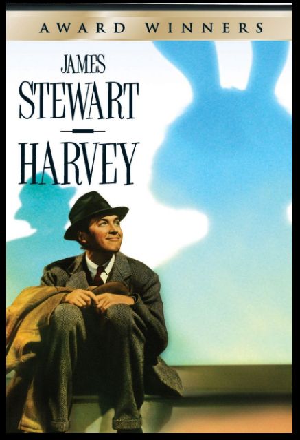 Movie poster for the movie HARVEY. A smiling Jimmy Stewart plays Elwood P. Dowd, and a shadow of a large rabbit shows behind him. 