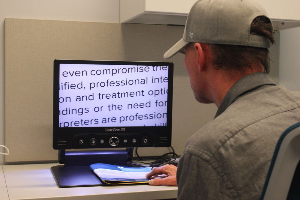 Ryan reading magnified text on a computer screen.