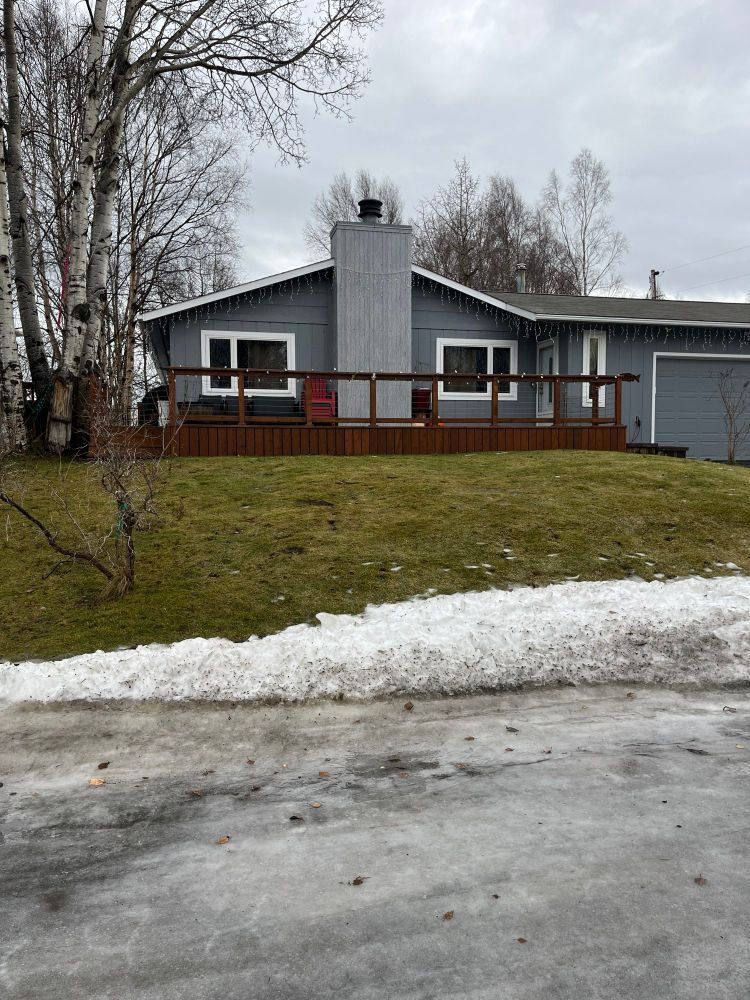 House in Alaska with no snow and grass showing.
