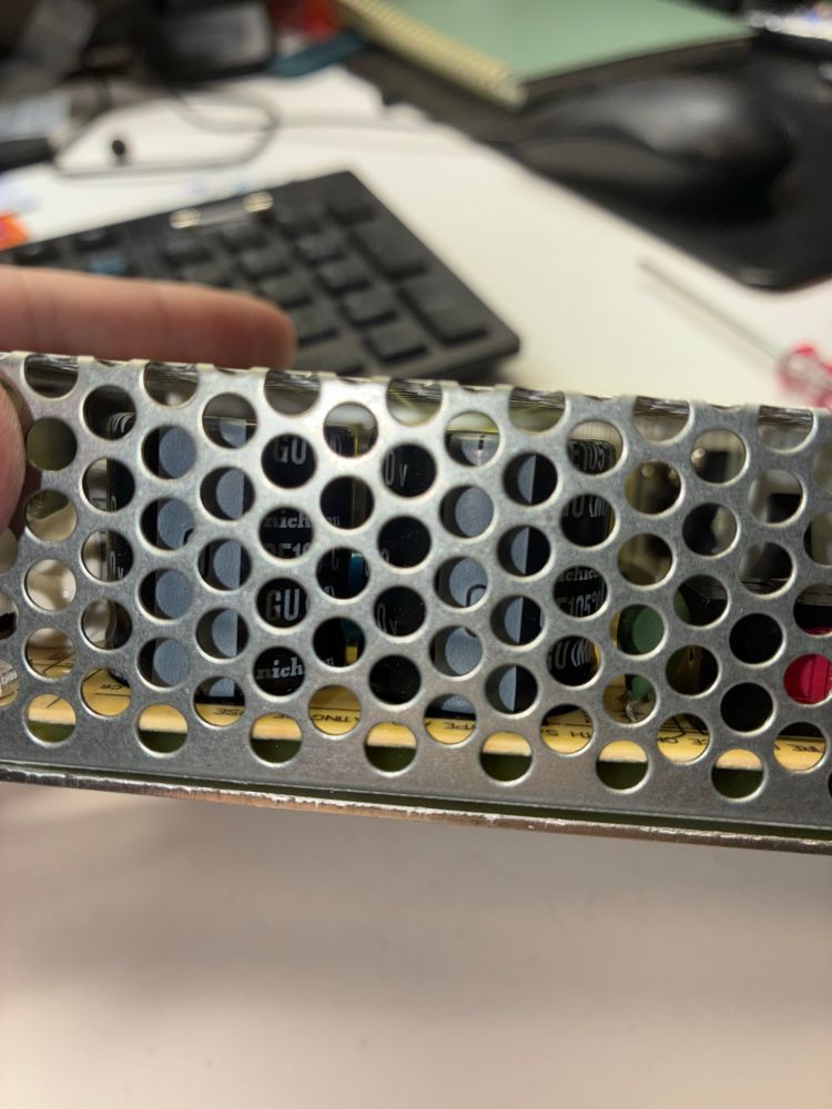 A new meanwell power supply. There’s about a centimeter gap between the upper “grate” and the top of the capacitors.