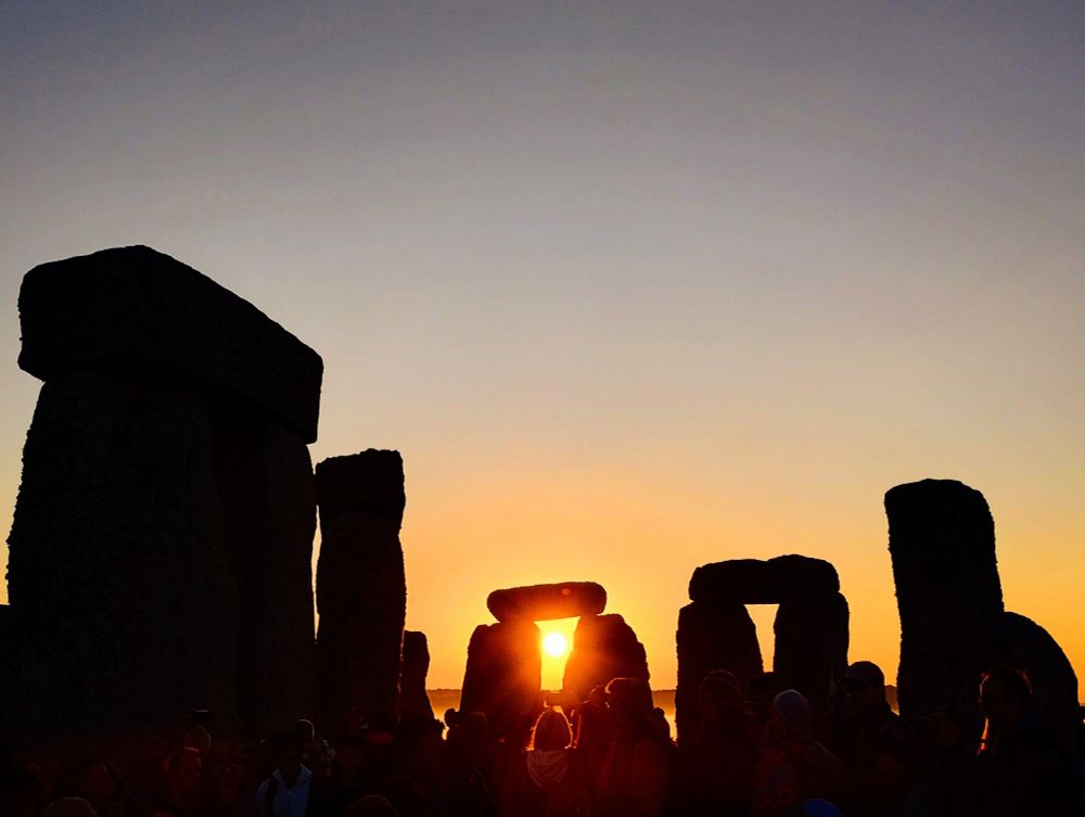 Stonehenge at sunrise, with the sun shining through the stones. 