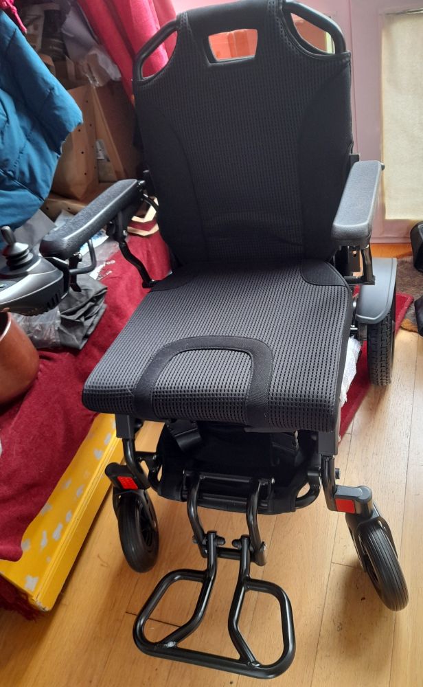 Power wheelchair ready to go in house hallway