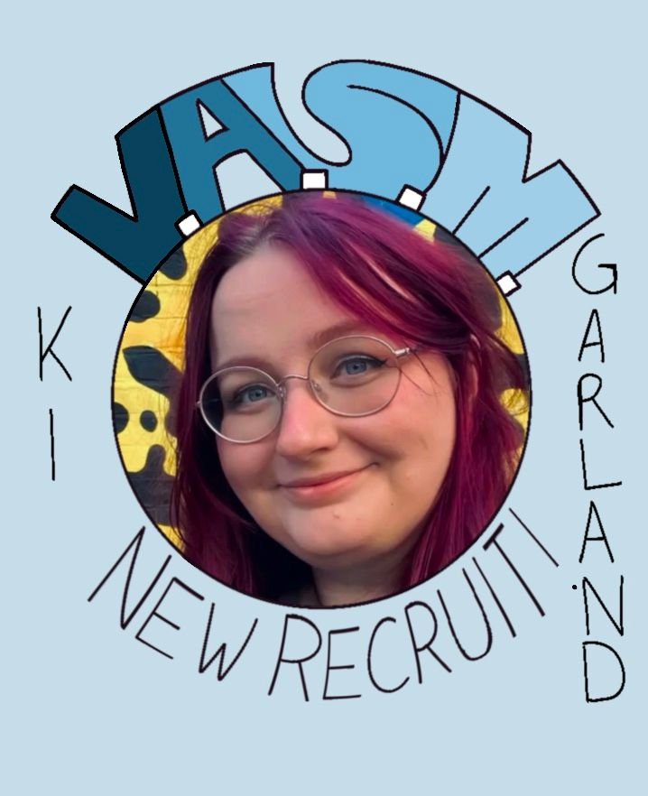 A circular picture of Ki Garland, with “V.A.S.M.” written above, “NEW RECRUIT!” written below, and “KI GARLAND” written on either side. The background is a light sky blue.