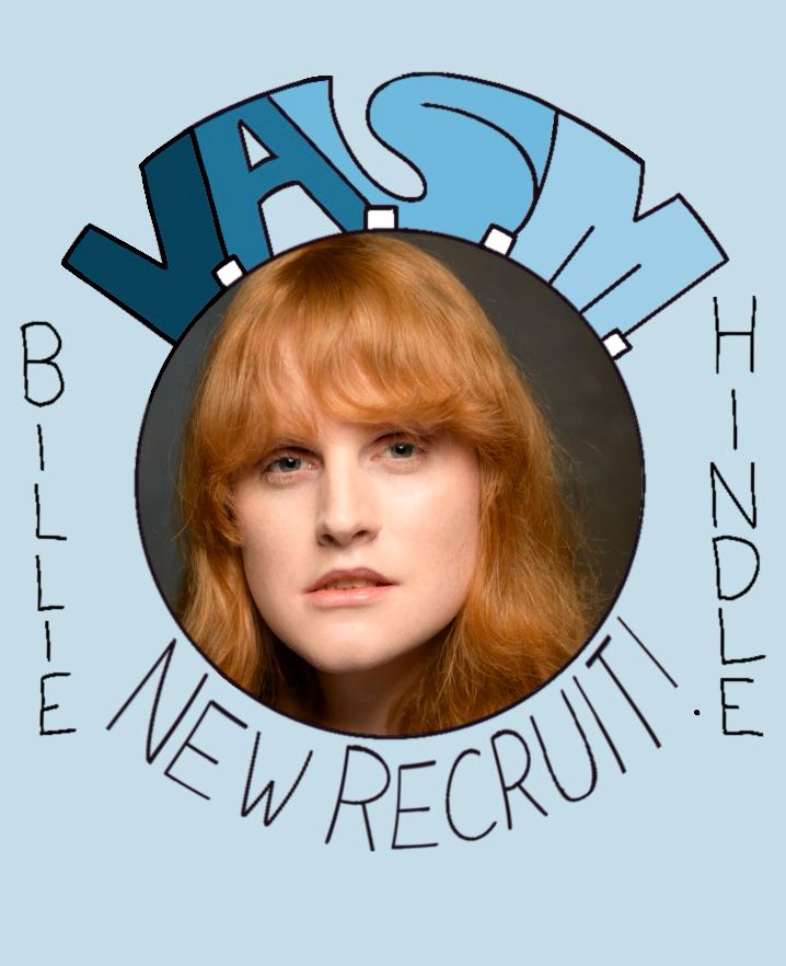 A circular picture of Billie Hindle, with “V.A.S.M.” written above, “NEW RECRUIT!” written below, and “BILLIE HINDLE” written on either side. The background is a light sky blue.