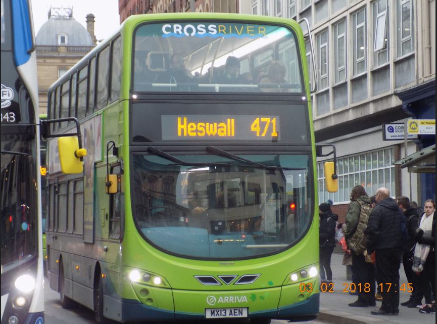 Two-tone green double deck bus on city street