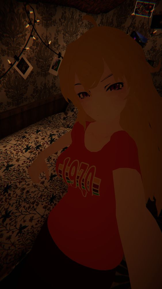 A VRChat selfie of Yang Xiao Long wearing an orange t-shirt and black pants while reclining on a bed in a warmly-lit room.