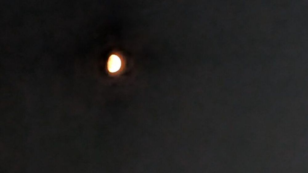 it's the moon! blurry in a dark sky!