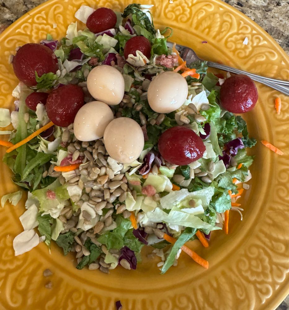 A shredded salad with eggs and stuff on it
