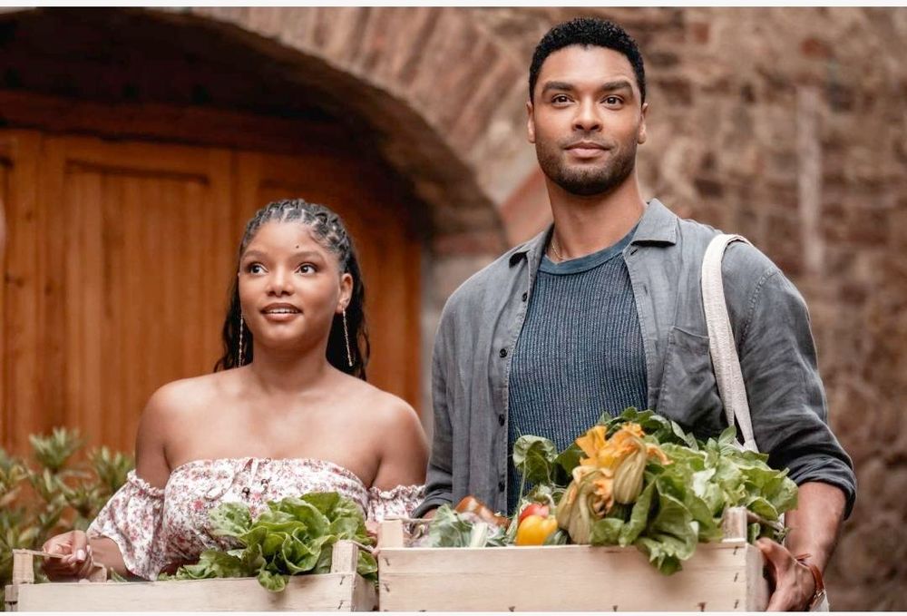 An extremely cute couple carrying around produce or something. She's got the cutest lil dimple chin and a sleeveless dress. He's wearing an open shirt over a tank and is smoldering like a lawful good paladin