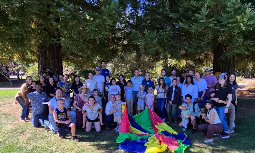 Group of people standing under trees outside