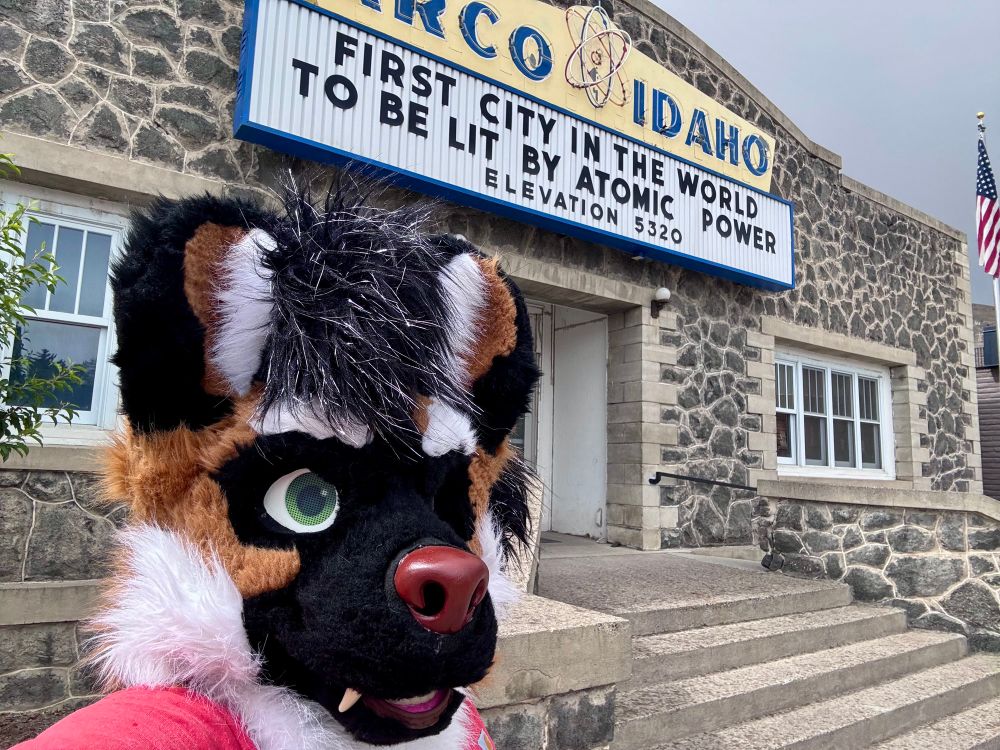 Gnoll in front of Arco Idaho sign