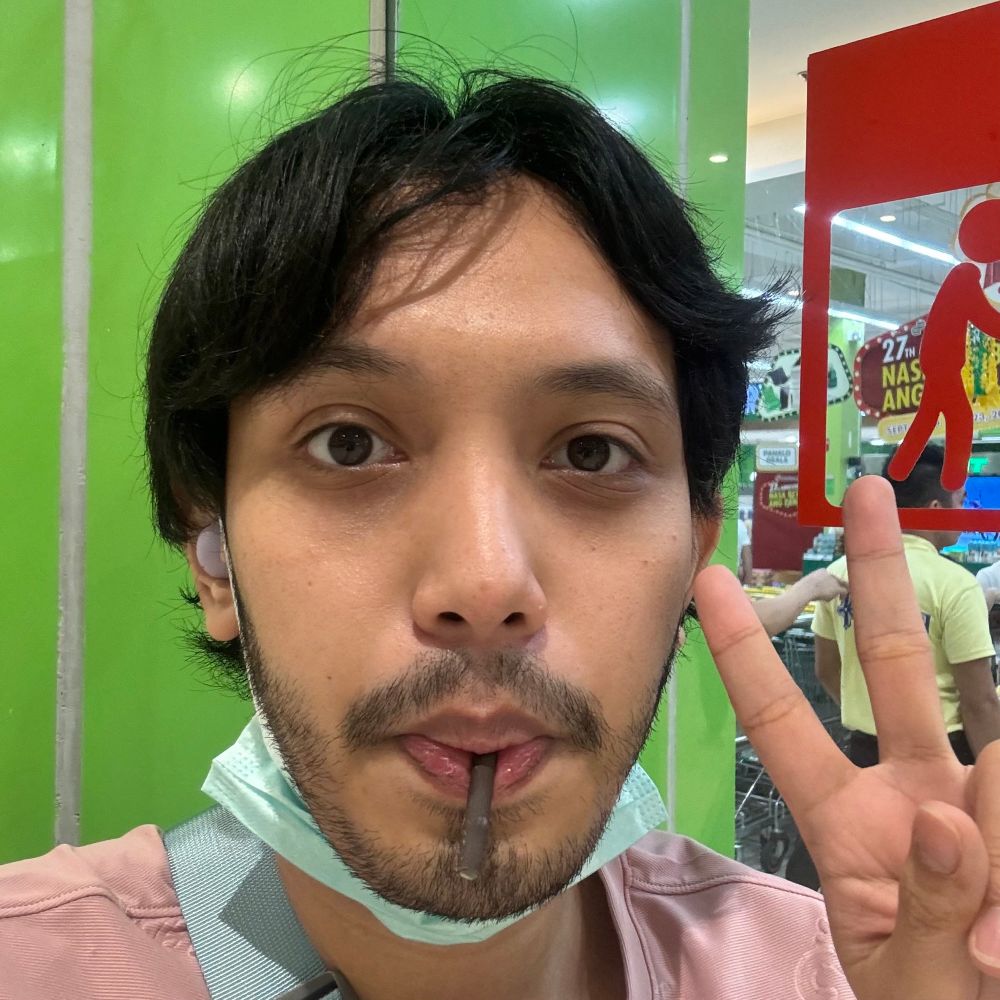 man with a pejoy in his mouth. also hi that man is me. i got some facial hair and some outgrowin hair.