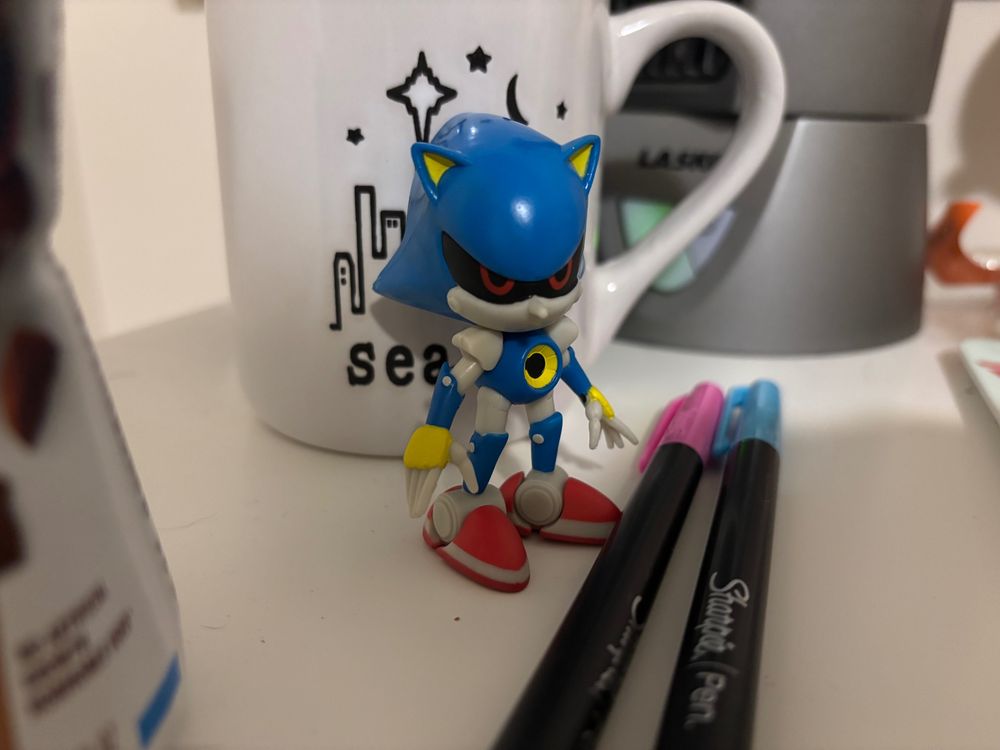 pic of metal sonic figurine in front of my seattle mug and behind my sharpie pens on my desk