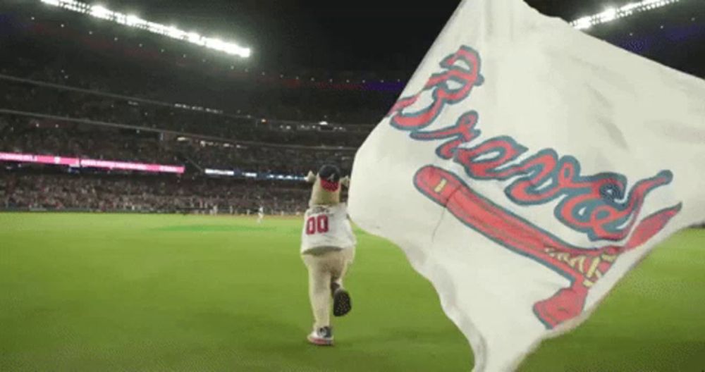 a person holding a flag that says braves