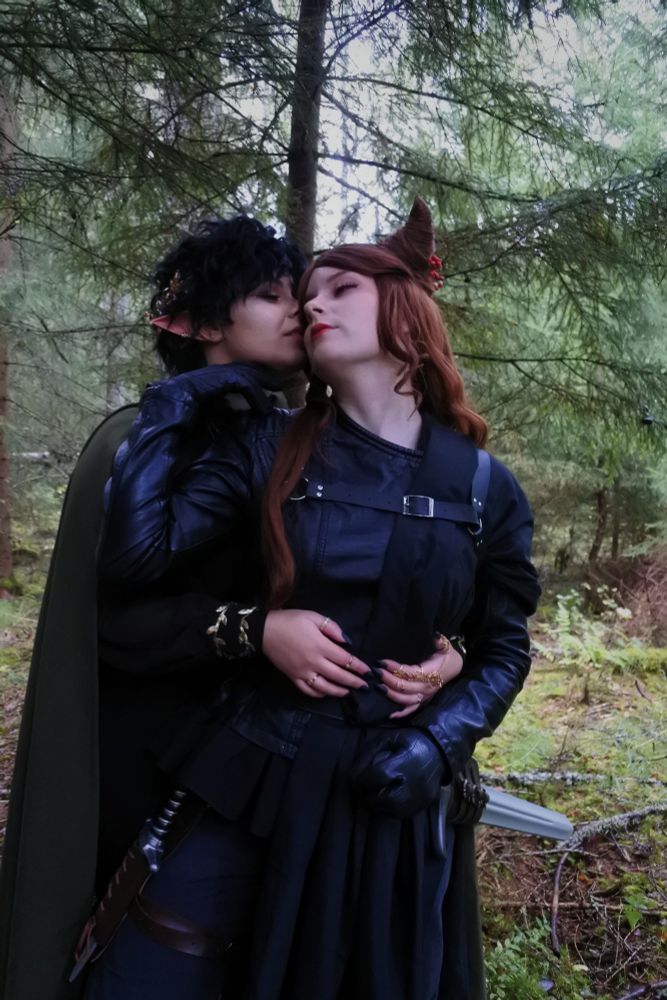 Cardan hugging Jude from behind, while she caresses his chin