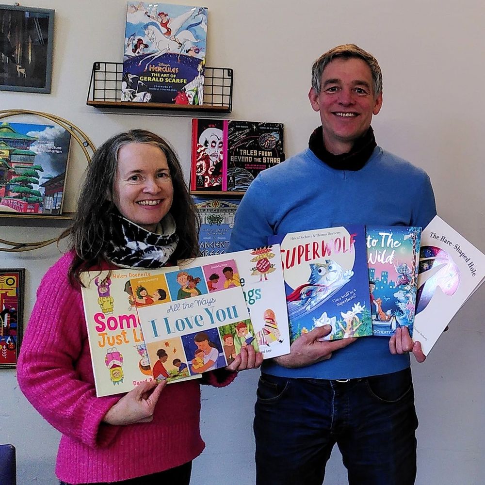 Helen and Thomas Docherty in the Rocketship Bookshop in Salisbury, with signed copies of their books: Someone Just like You, All The Ways I Love You, All The Things We Carry, Superwolf, Into The Wild and The Hare-Shaped Hole