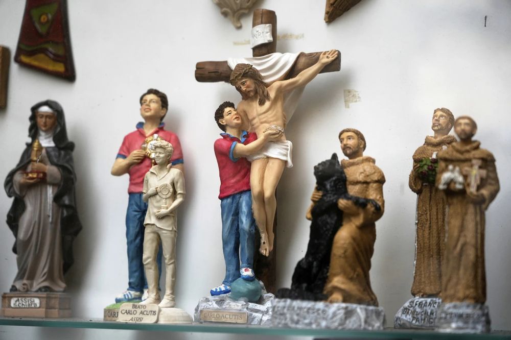 Jesus on a cross being hugged(?) by the most recent saint, who is apparently much taller, and all I can think of is Jesus asking for a little fucking help here, please. “Just get the other hand, we’re good.”