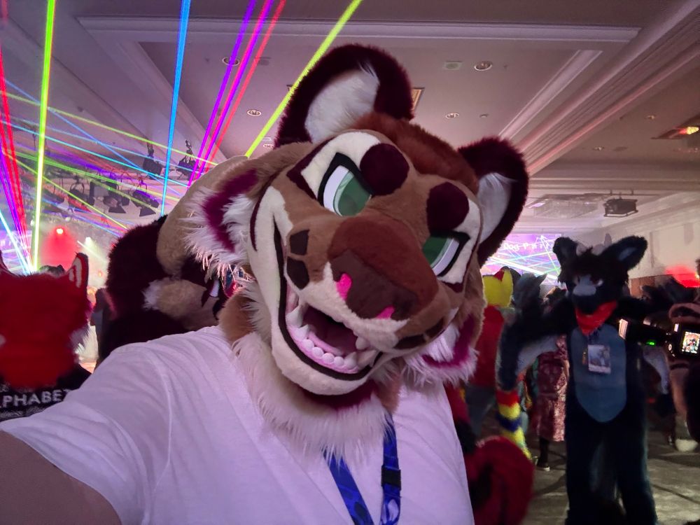 Saturn takes a selfie at the Dead Dog dance, with multicoloured lasers firing off in the background.