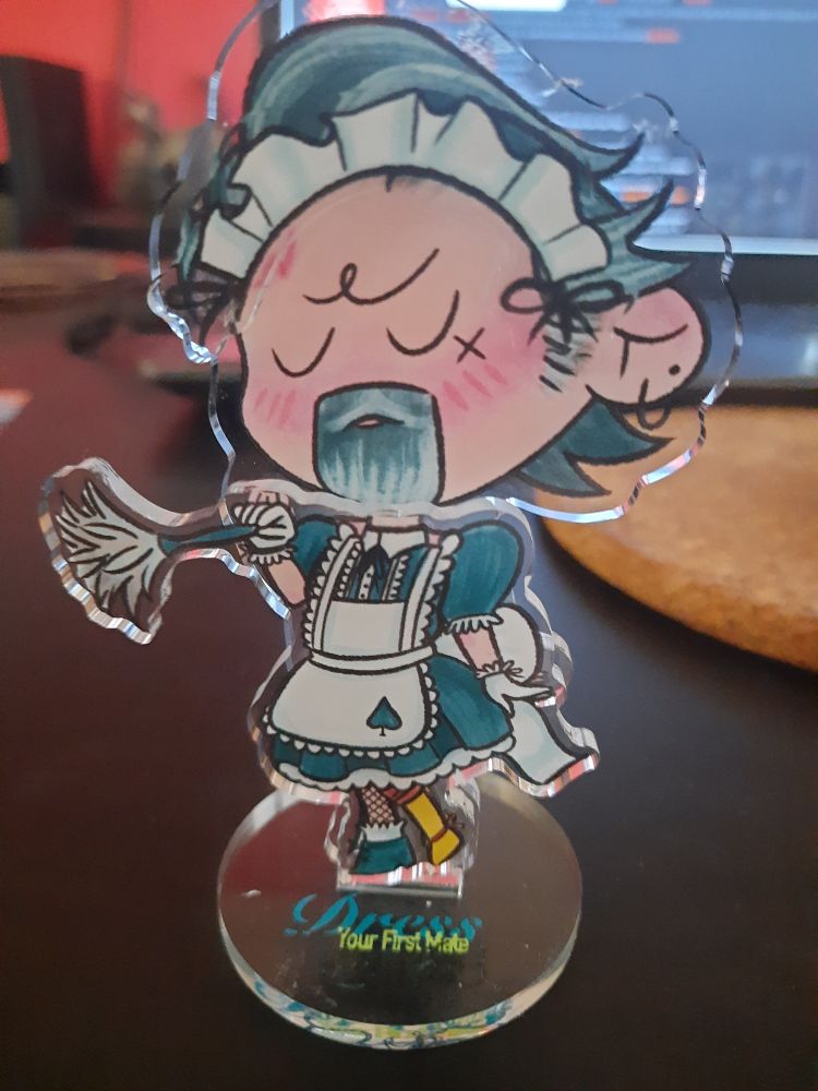 The same standee, wearing a maid's uniform and holding a duster.