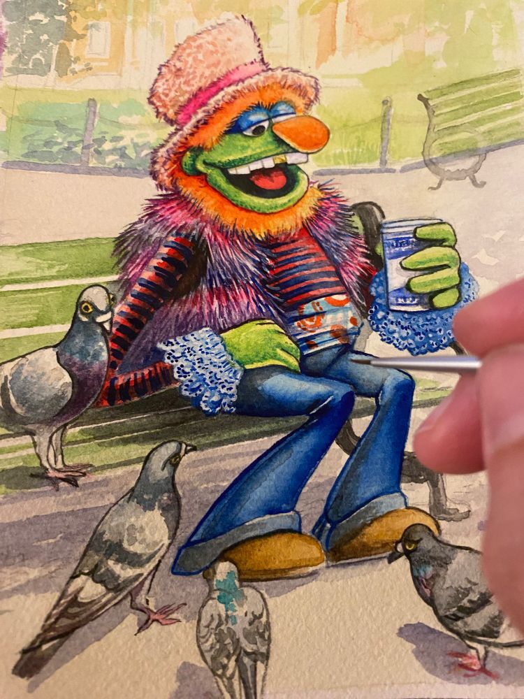 A watercolour illustration of Dr.Teeth, sitting on a park bench with a take-out coffee cup. There are pigeons surrounding him. 