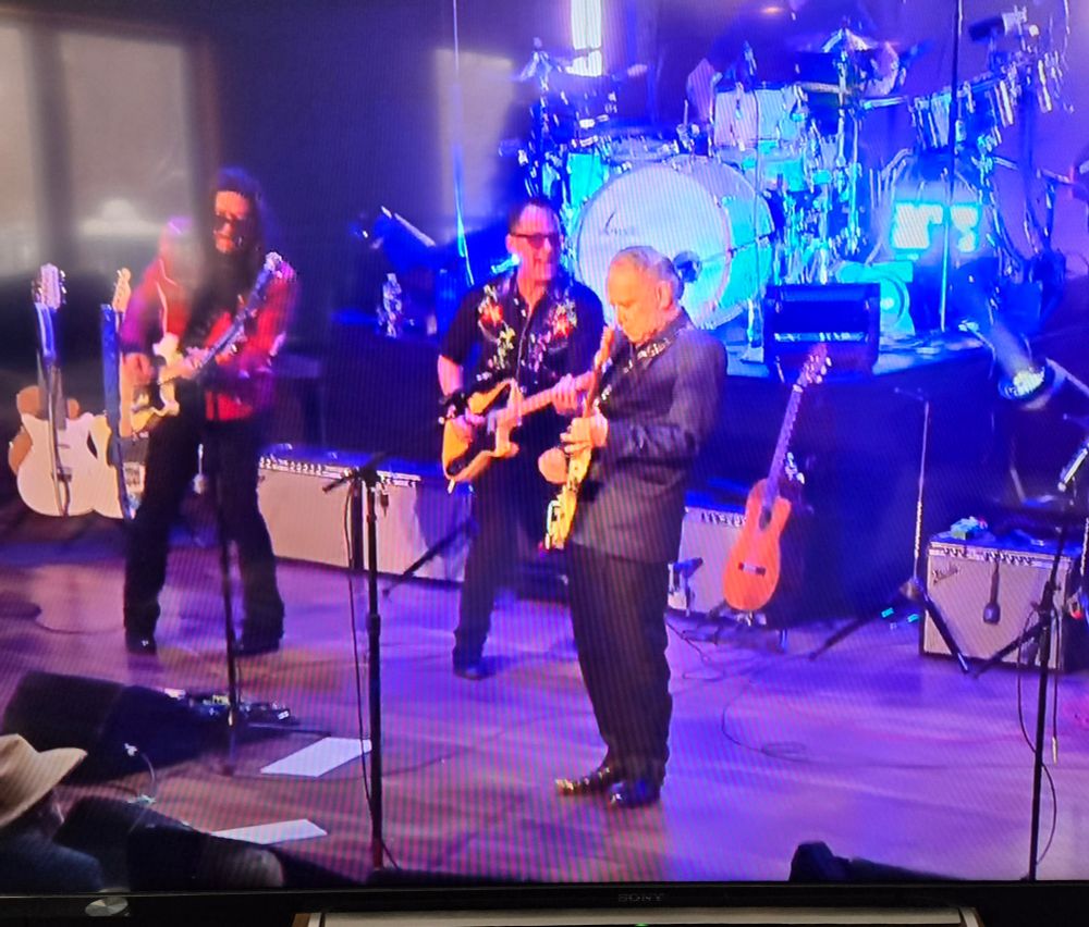 Eddie Perez, Jaime Hanna, Jimmie Vaughan onstage the a Ryman theater in Nashville, 12/5/2025