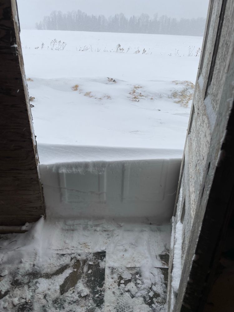 Snow piled against door. 
