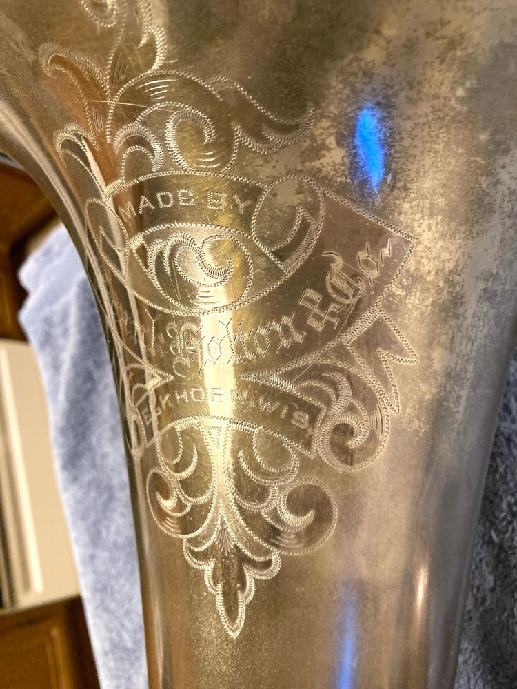 Another try at showing the engraving, with flourishes and ribbons that say “made by Frank Holton & Co, Elkhorn, Wis.”