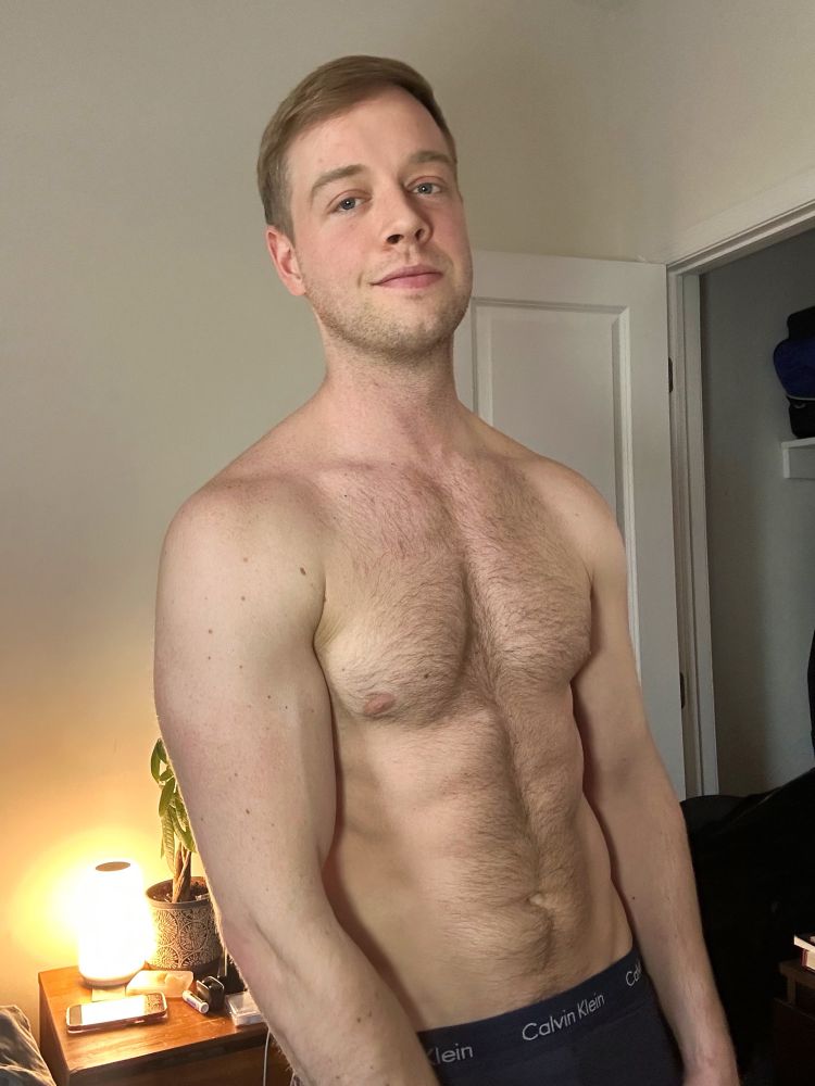 Gay shirtless man in bedroom 