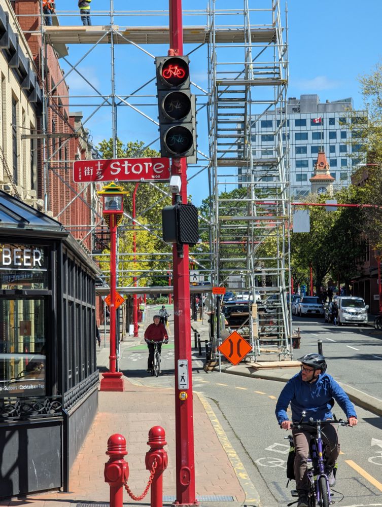 Building scaffolding spanning the Pandora bike lanes in 2024. The scaffolding creates a bridge over the bike lane, which remained open.