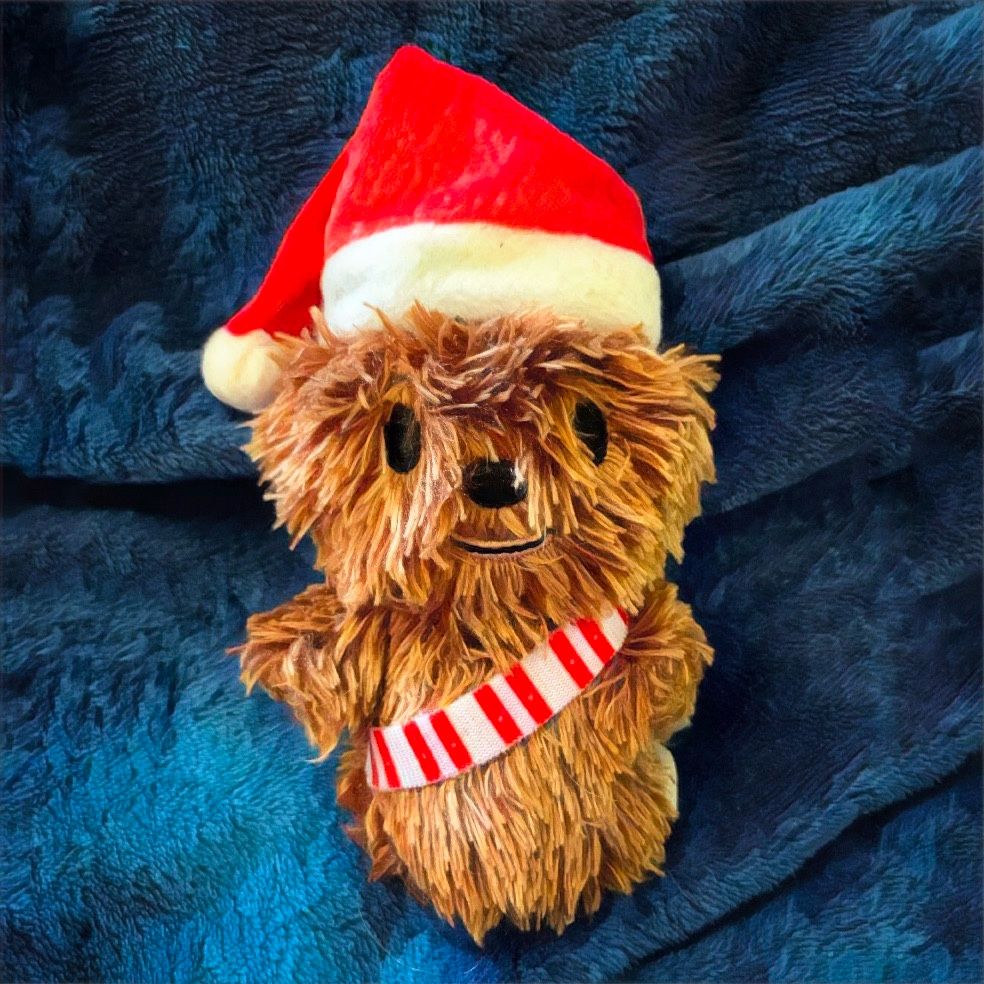 A Christmas Chewbacca Itty Bitty on a blue blanket
