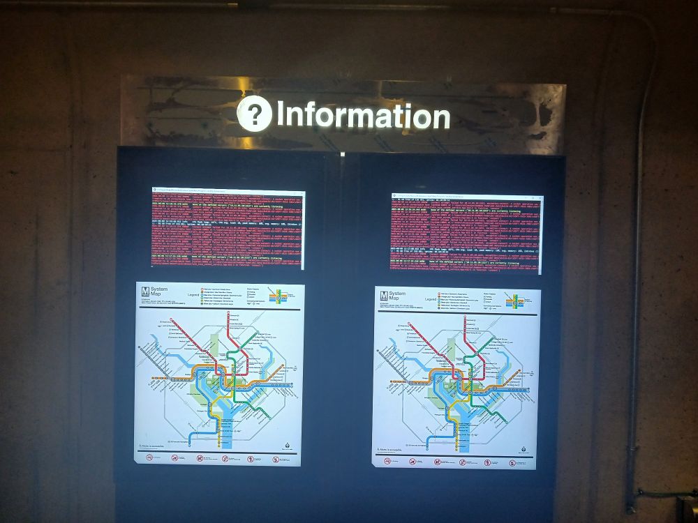 Side-by-side portrait-orientation electronic displays with diagnostic messages at the tops of both and rail system diagrams at the bottoms of both.
