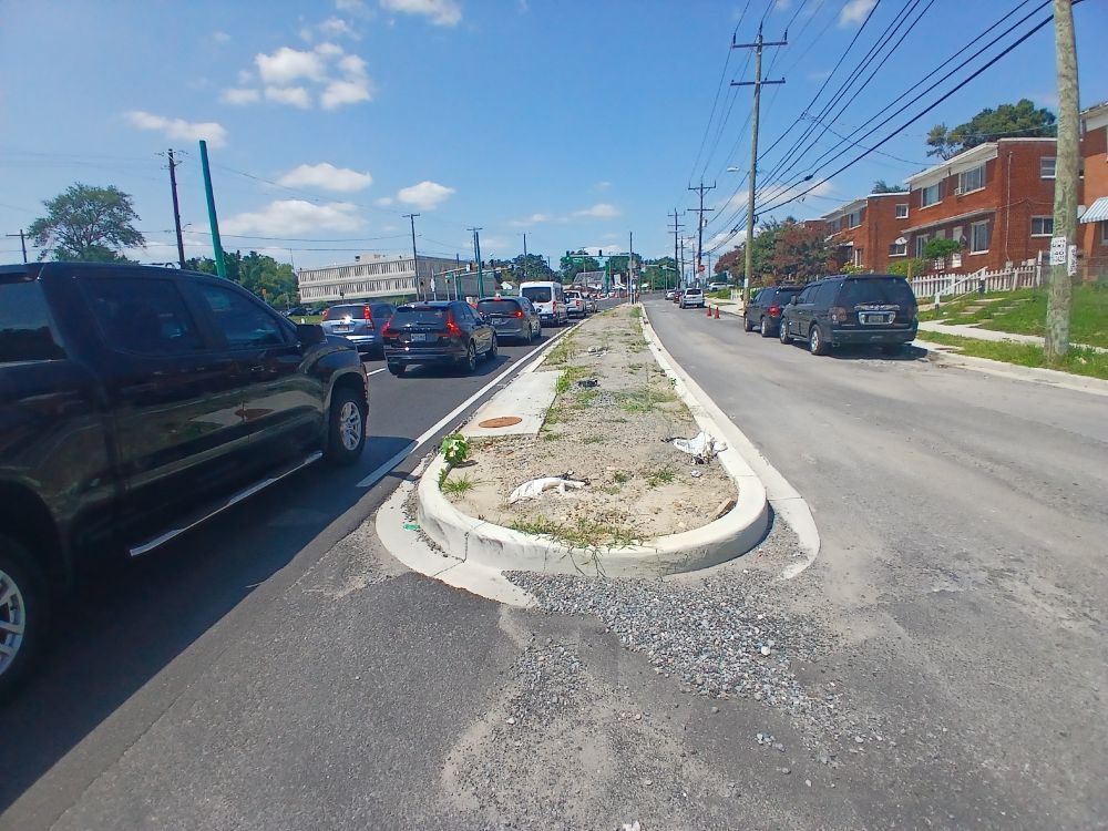 Just outside Takoma Park, Maryland, view west along north side of University Boulevard from Navahoe Street. No school crossing signage is visible.