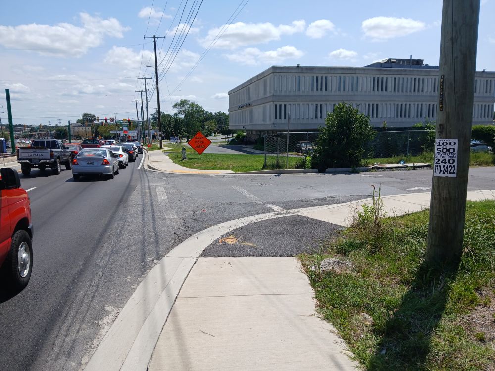 In Silver Spring, Maryland, view east along south side of University Boulevard across Forston Street. No street name signs are visible.