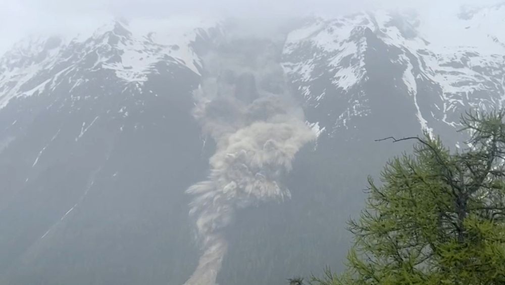 A screenshot from a video of a landslide explosively crashing down a mountainside. (Pomona Media / Reuters)