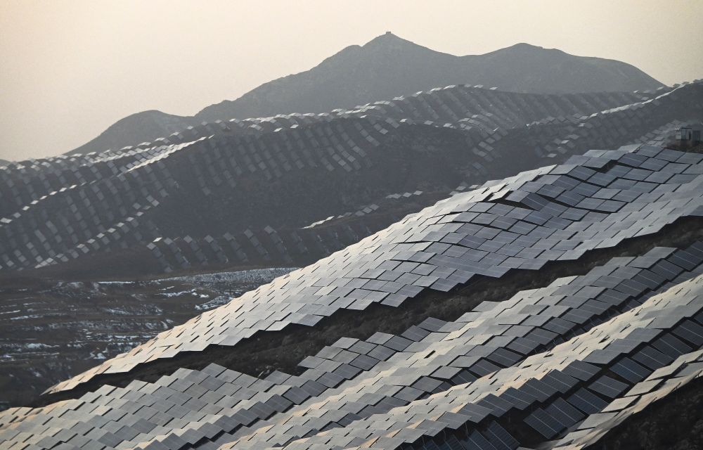 An aerial view of solar panels covering several hillsides. (Greg Baker / AFP / Getty)