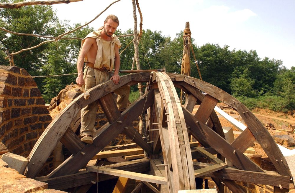 A carpenter works on support timbers for a rounded roof. (Xavier Rossi / Gamma-Rapho / Getty)
