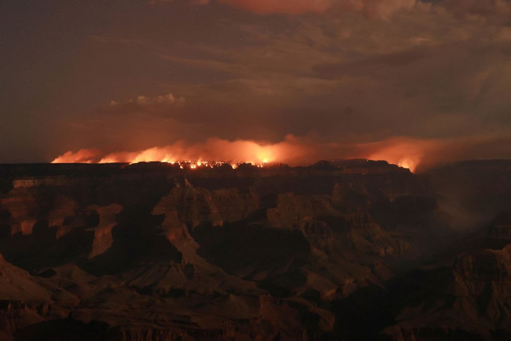 A broad nighttime view of a wildfire burning along the Grand Canyon (David Swanson / Reuters)