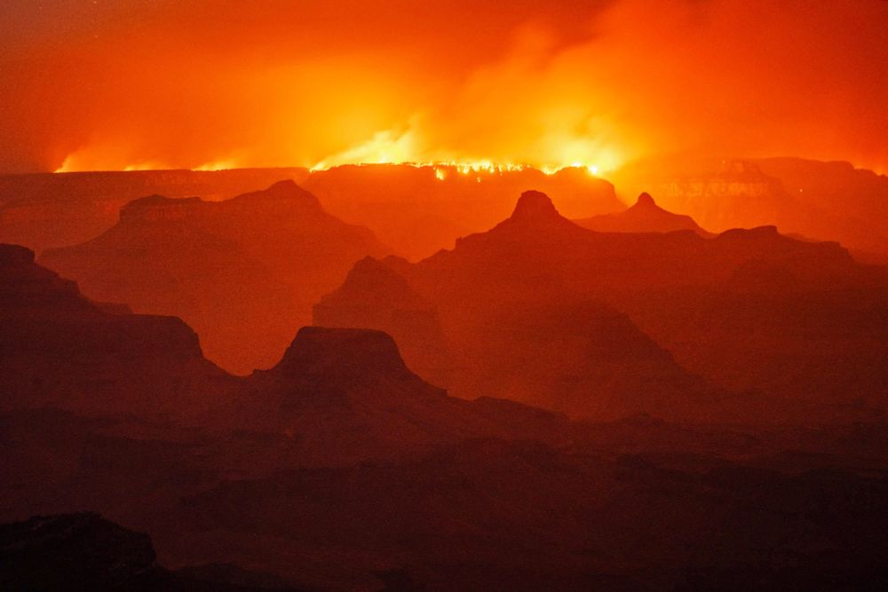A night view of a smoky Grand Canyon, with a wildfire burning along the far rim (Michael Chow / The Arizona Republic / USA Today / Reuters)
