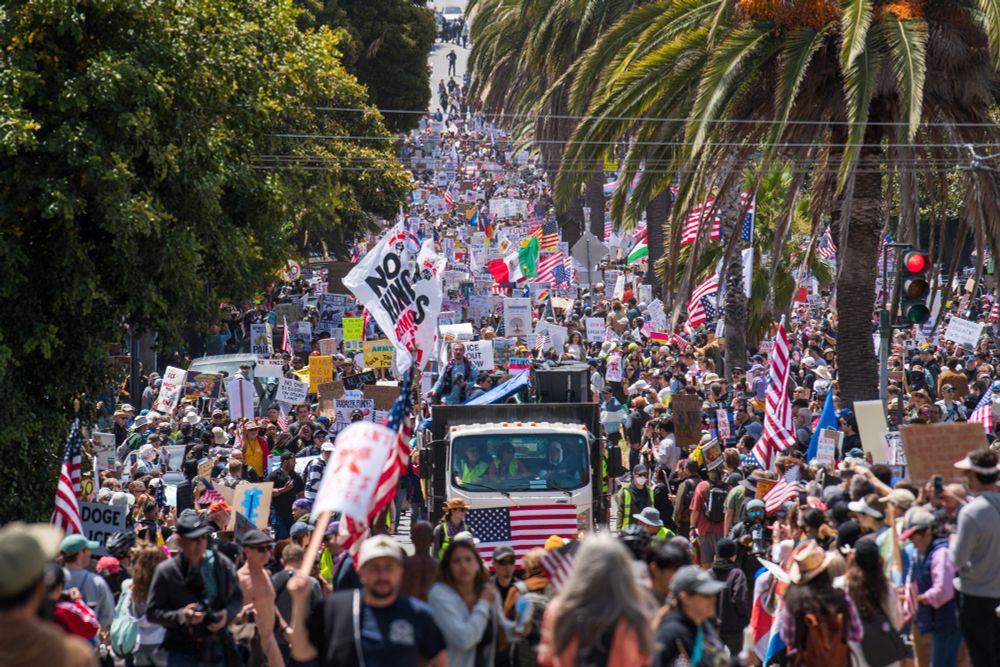 Demonstrators hold signs as they march down a city street in San Francisco. (Nic Coury / AFP / Getty)