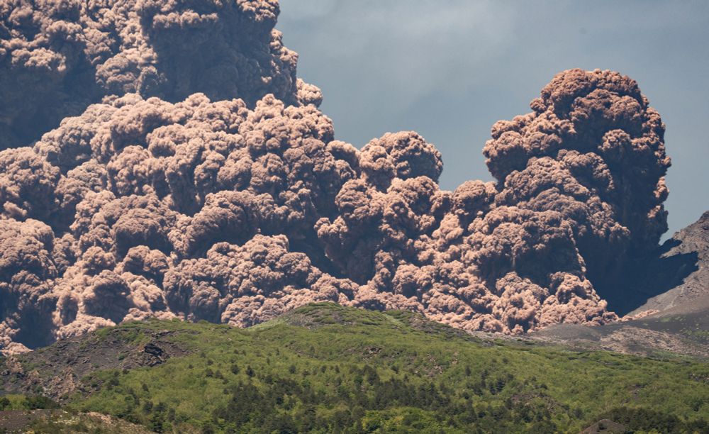 Plumes of volcanic ash rise from a volcano. (Marco Restivo / Reuters)