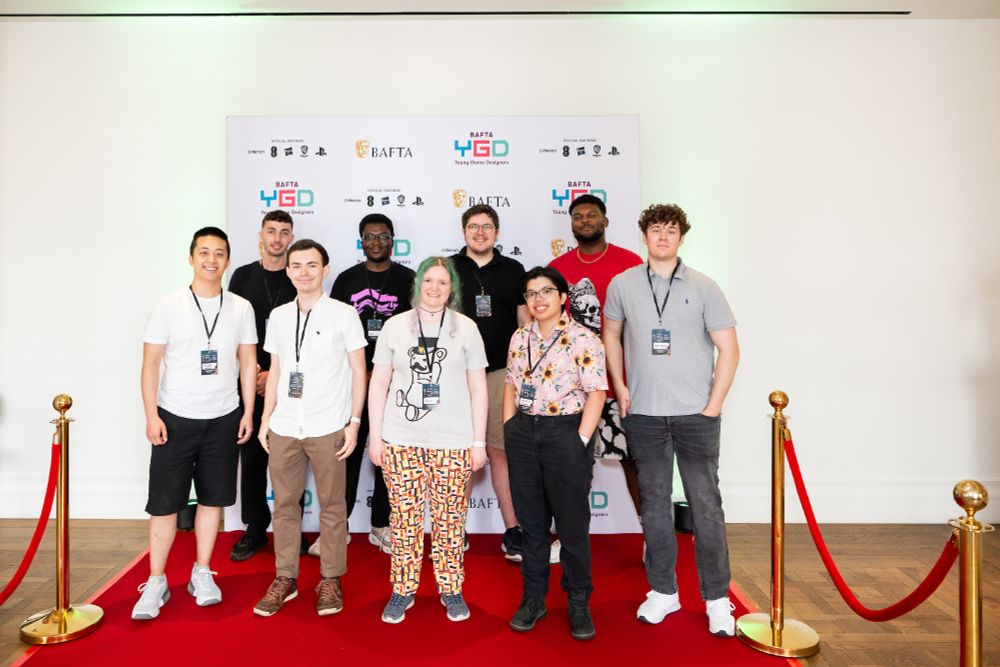 Cameryn Tuliao in a pink button up with sunflowers, standing with the rest of the BAFTA YGD alumni at the event. This picture was taken at BAFTA YGD Showcase 2025, photographed by ©BAFTA/Alecsandra Dragoi
