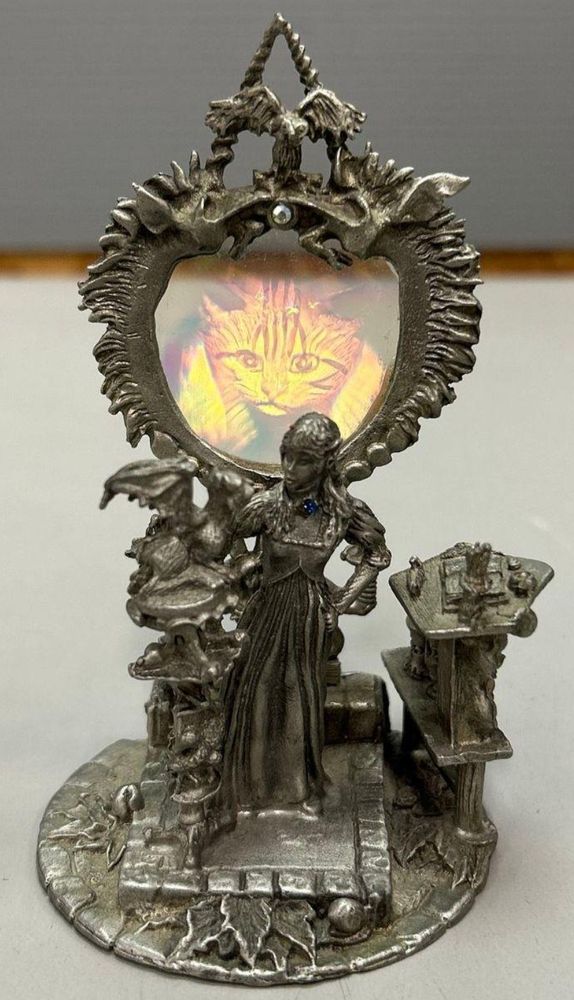 A lil pewter figurine of me, having eschewed the folly of science for the proven winner which is black magic. I've got my books out and my dragon perched, and I'm holographic zooming with the cat who is dressed as an emperor and can talk.
