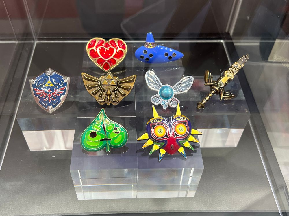 Various Zelda pins, including Korok, shield, heart, ocarina and Navi.