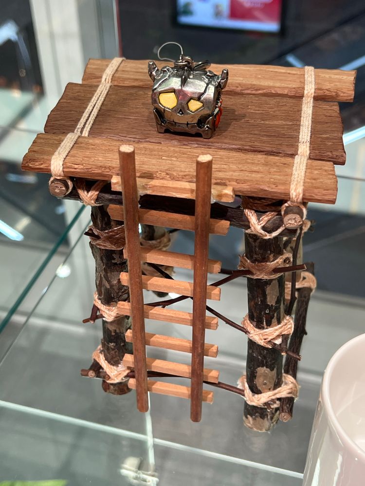 Boss chest keychain presented on a wooden platform