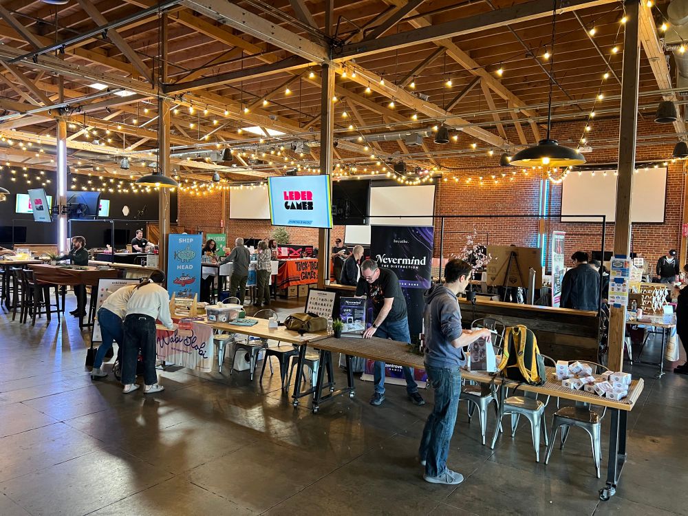 People busy setting up tables for Game Market West