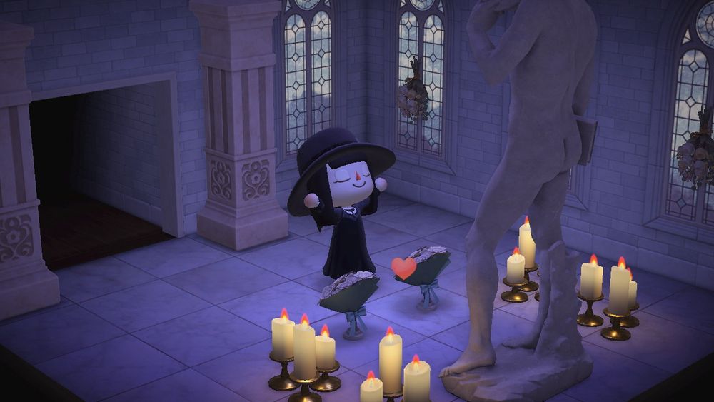 androgynous animal crossing guy with his arms up looking blissful as he worships in a church themed side room filled with candles in front of the naked statue of david 