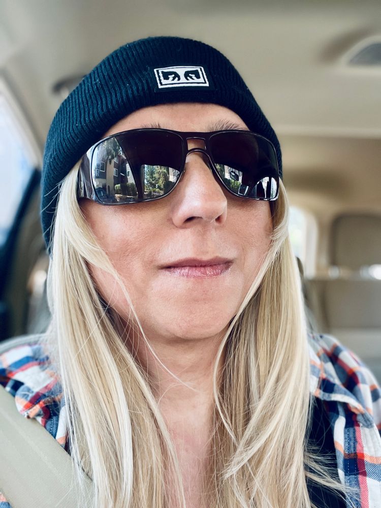 Portrait of Saví wearing a black Obey beanie and D&G sunglasses.