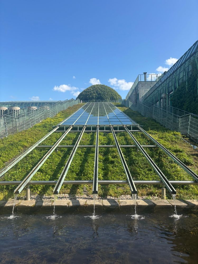 Solar panels and water feature on stairs at the Roof Garden at University Library in Warsaw. 