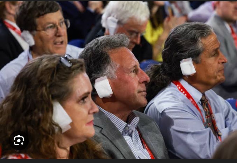 Photo of GOP convention attendees wearing bandages over their ears to mimic Trump post Butler fairgrounds assassination attempt 
