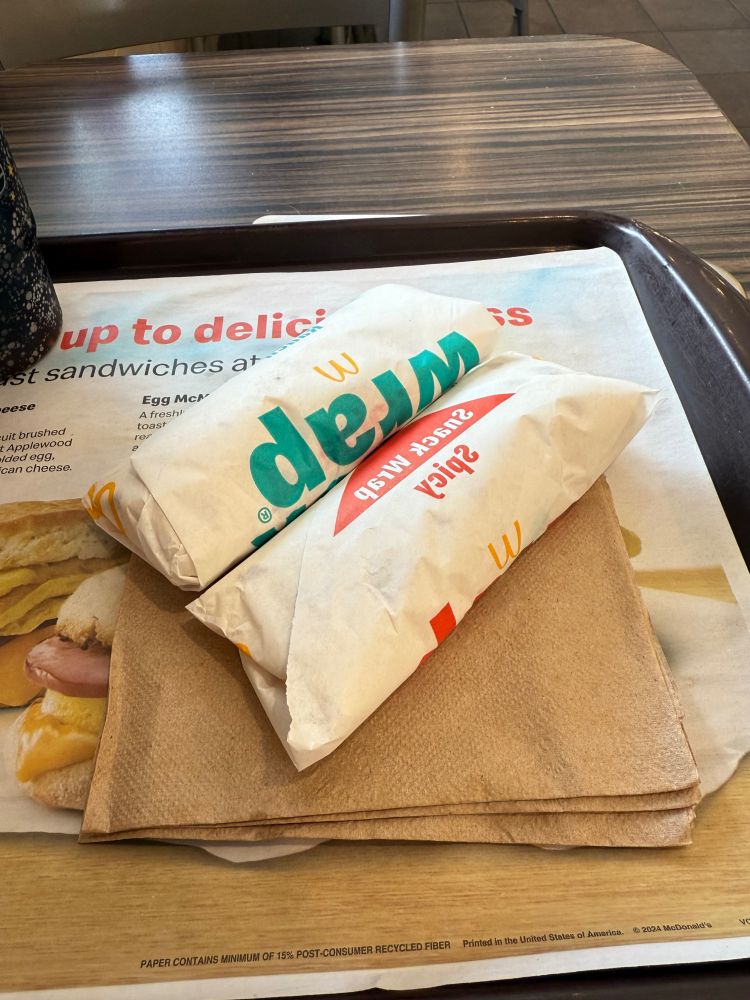 A ranch and a spicy Snack Wrap arranged on a McDonald's tray.